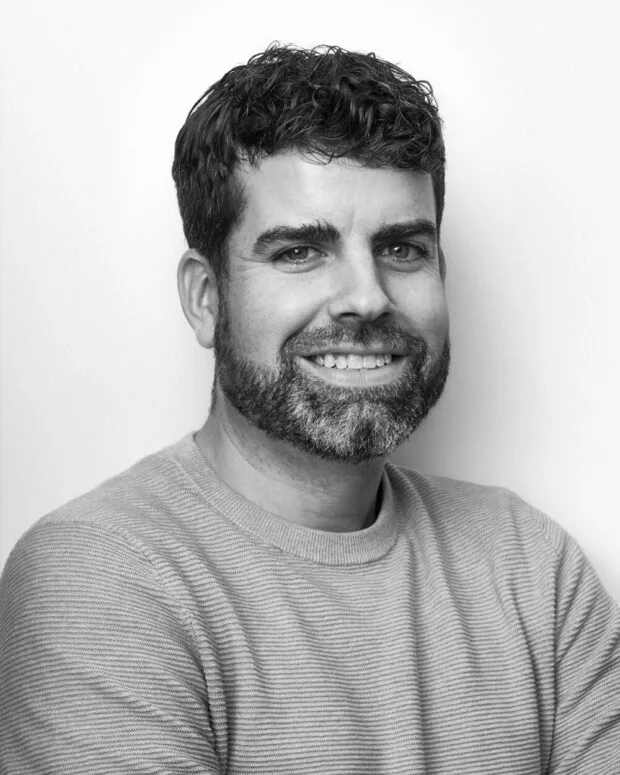A black and white portrait of Patrick Boothe