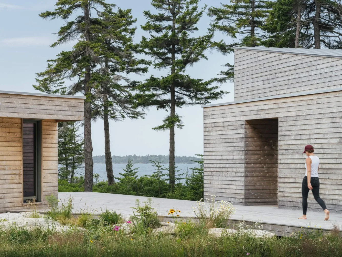 Harbor Point by Woodhull Architects, with minimalist cedar-clad volumes, coastal views, and a central breezeway courtyard