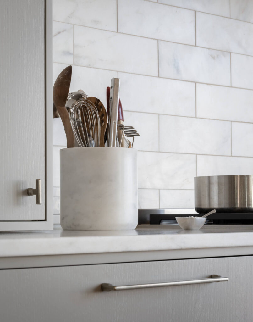 A utensil holder sitting on a kitchen counter