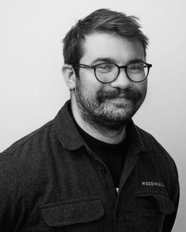 A black and white portrait of Drew Zembruski