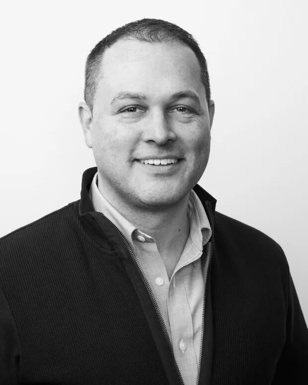 A black and white portrait of Bill Carr