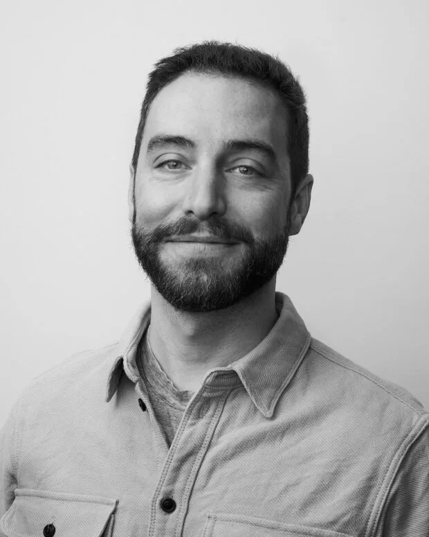 A black and white portrait of Mike Latona