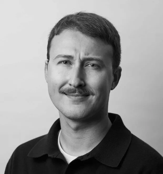 A black and white portrait of Alexander Sheremet