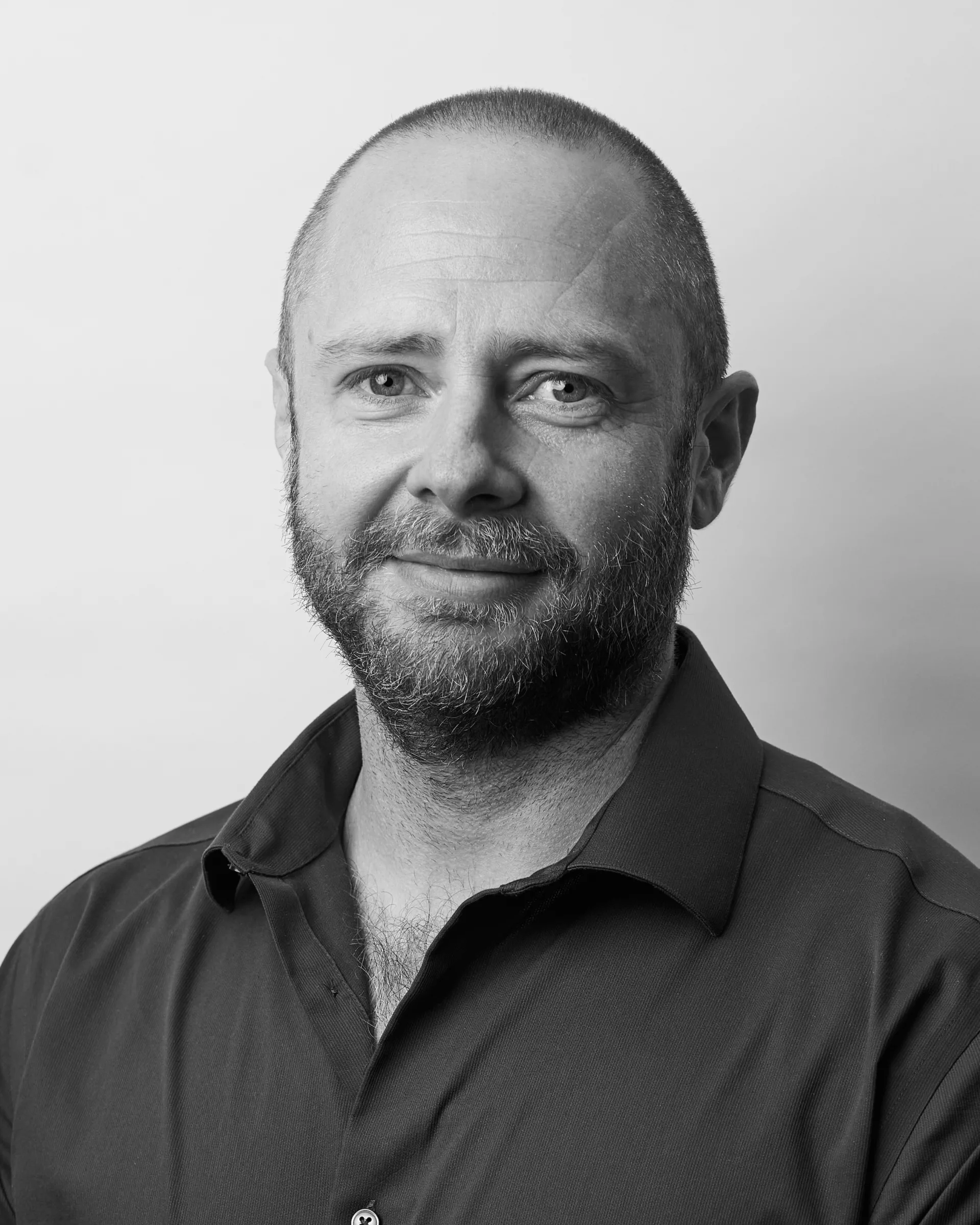 A black and white portrait of Butch Mockler