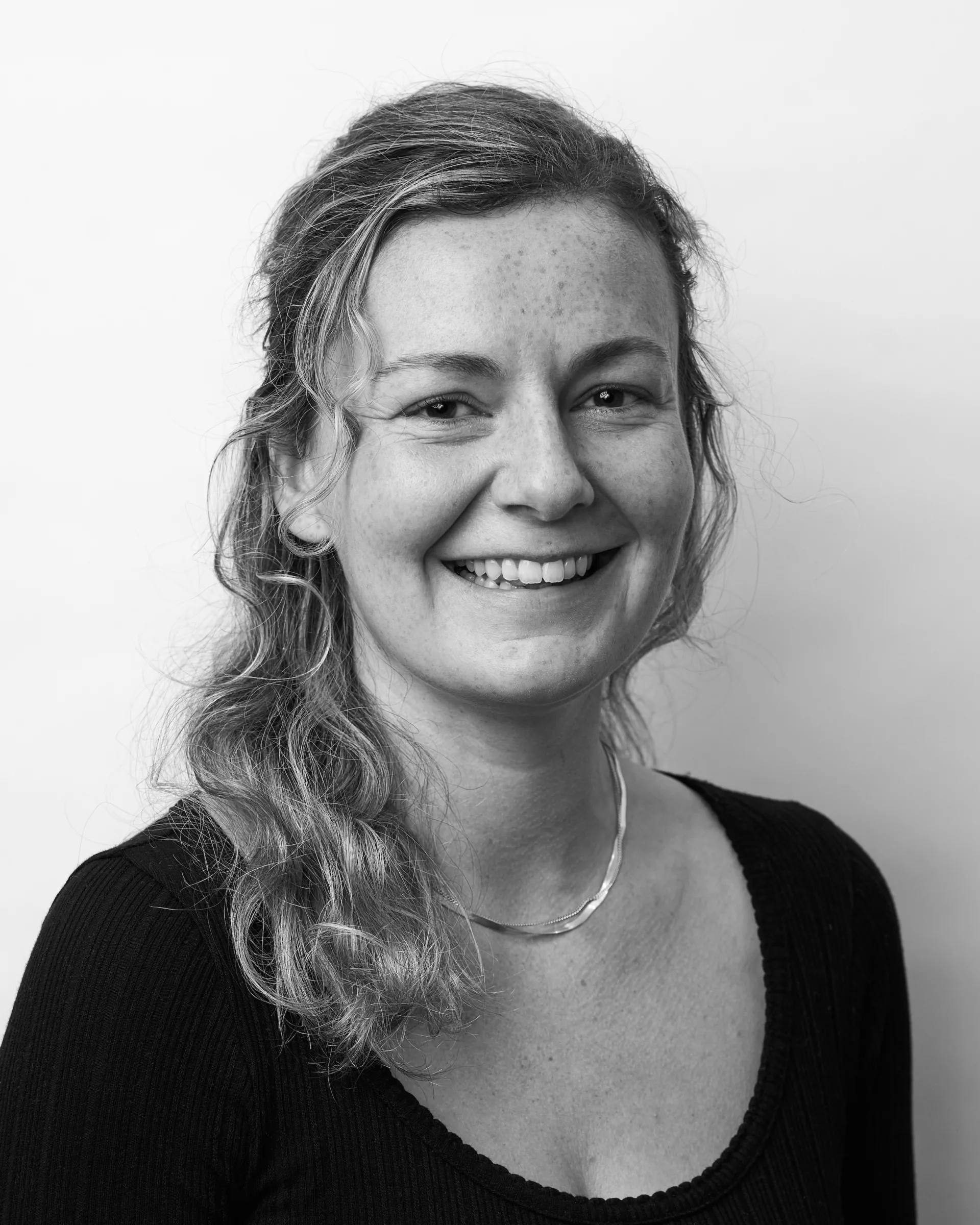 A black and white portrait of Emma Olson