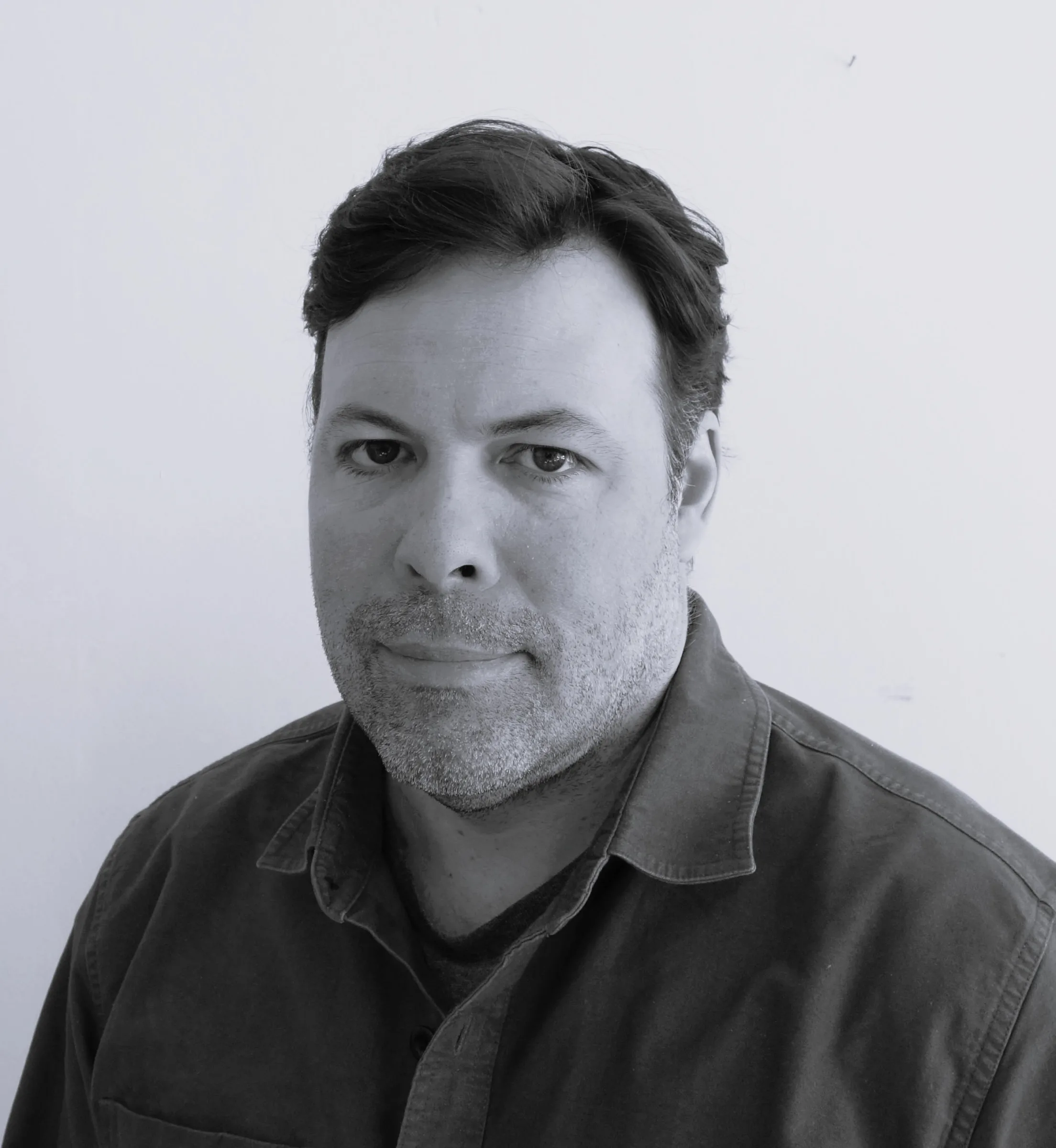 A black and white portrait of Tony DeLorenzo