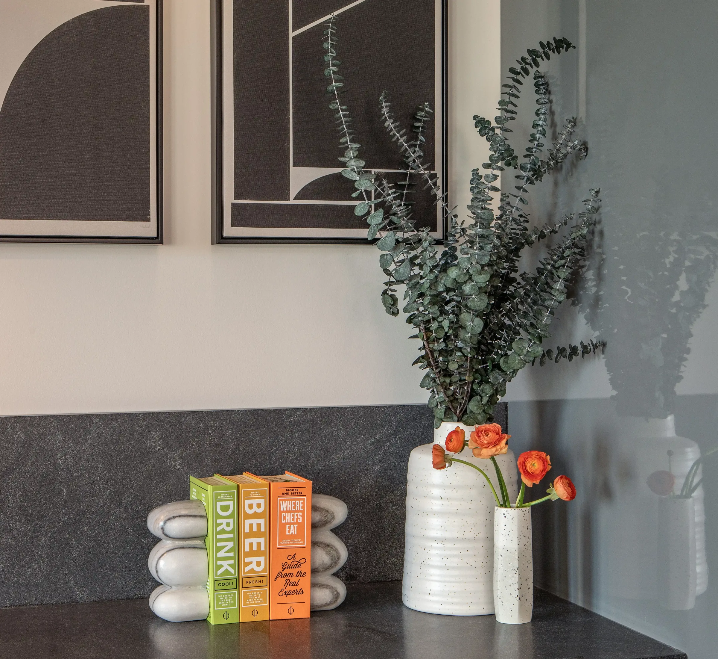 Several vases and books on a shelf at the Weldon Hotel