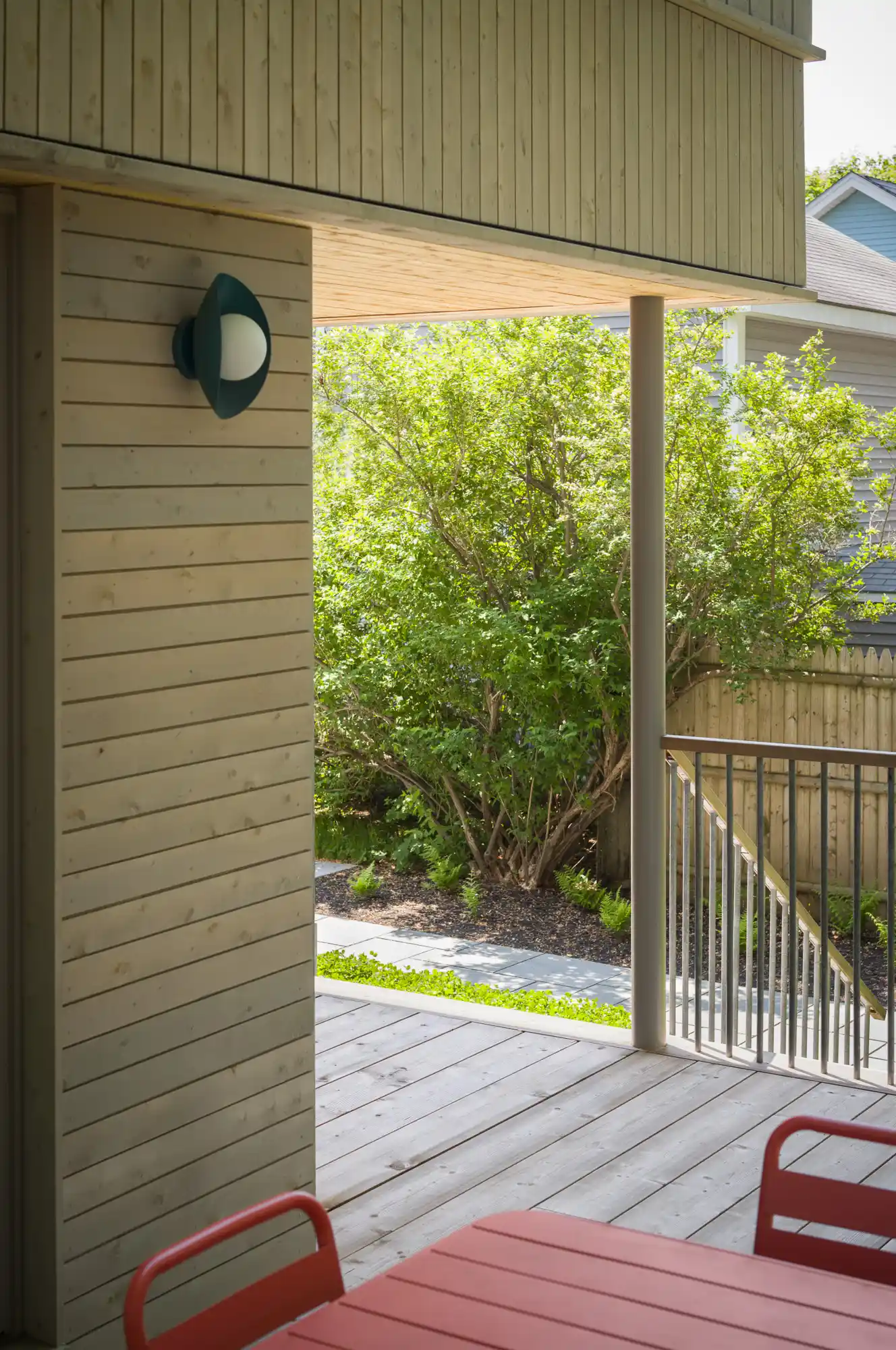 Angled view of modern front porch with stairs on contemporary Willard Cube home